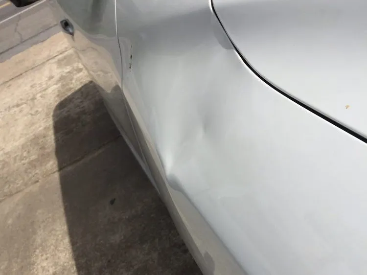 Paintless dent repair of a crease along a body feature line — before
