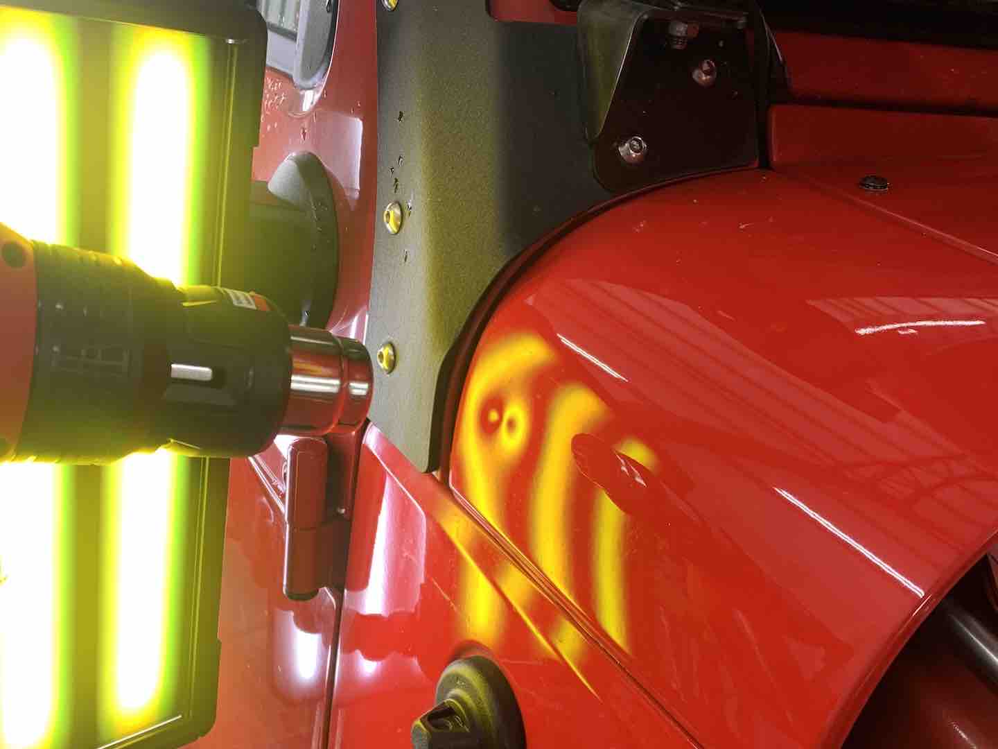 Paintless dent repair of a dent on a Jeep body panel — before