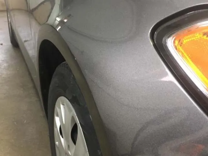 Paintless dent repair of a dent on a car quarter panel — after